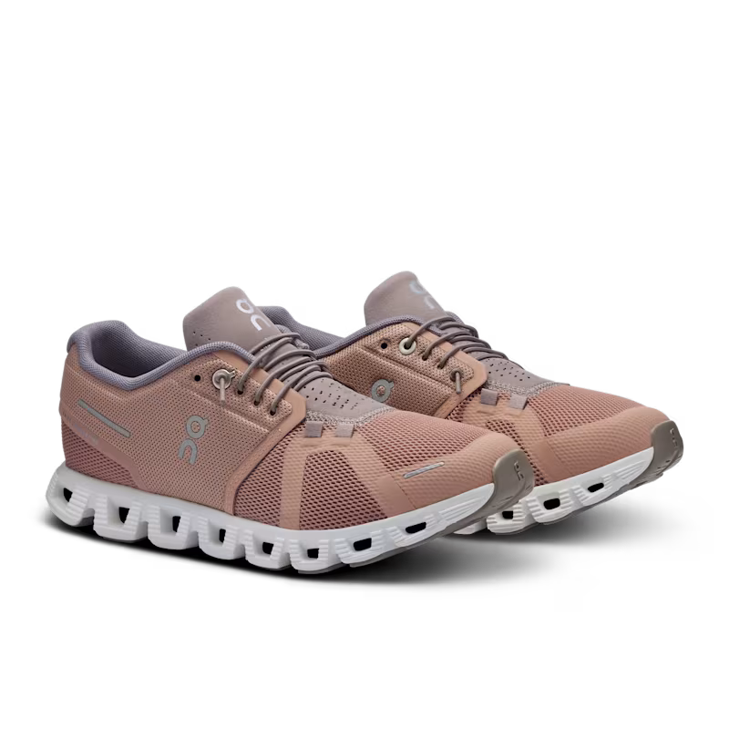 Pair of pink running shoes with white soles on a transparent background