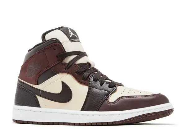 Brown and white sneaker with a prominent logo on a white background