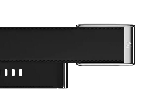 Close-up of a black electronic device with metallic accents on a white background