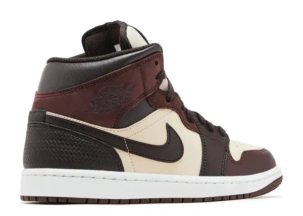 Brown and black sneaker with a white logo on a white background