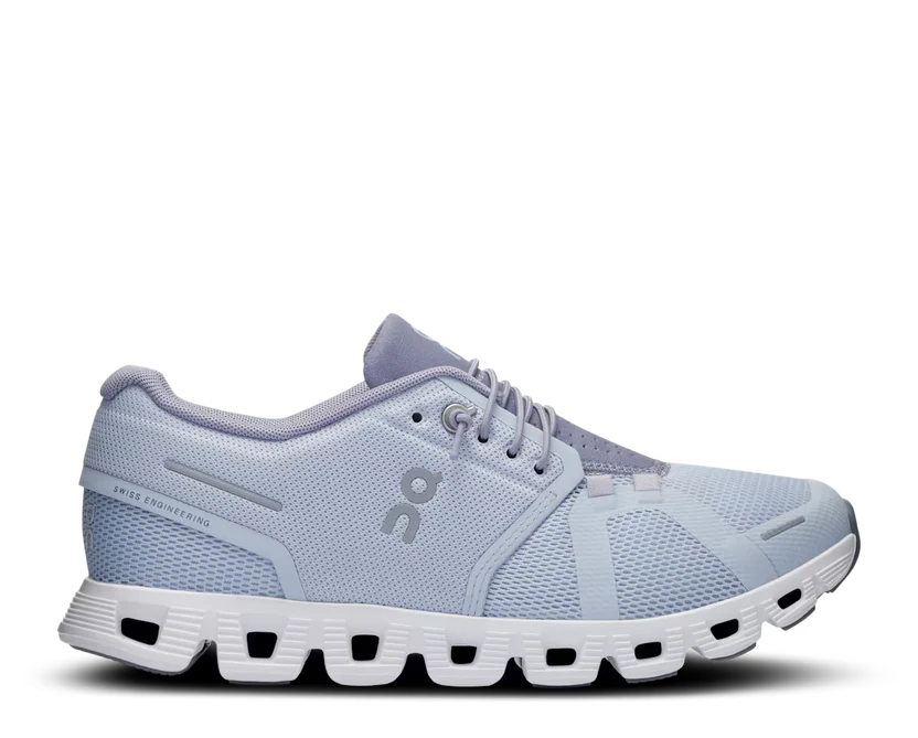 Light blue running shoe with white sole on a white background