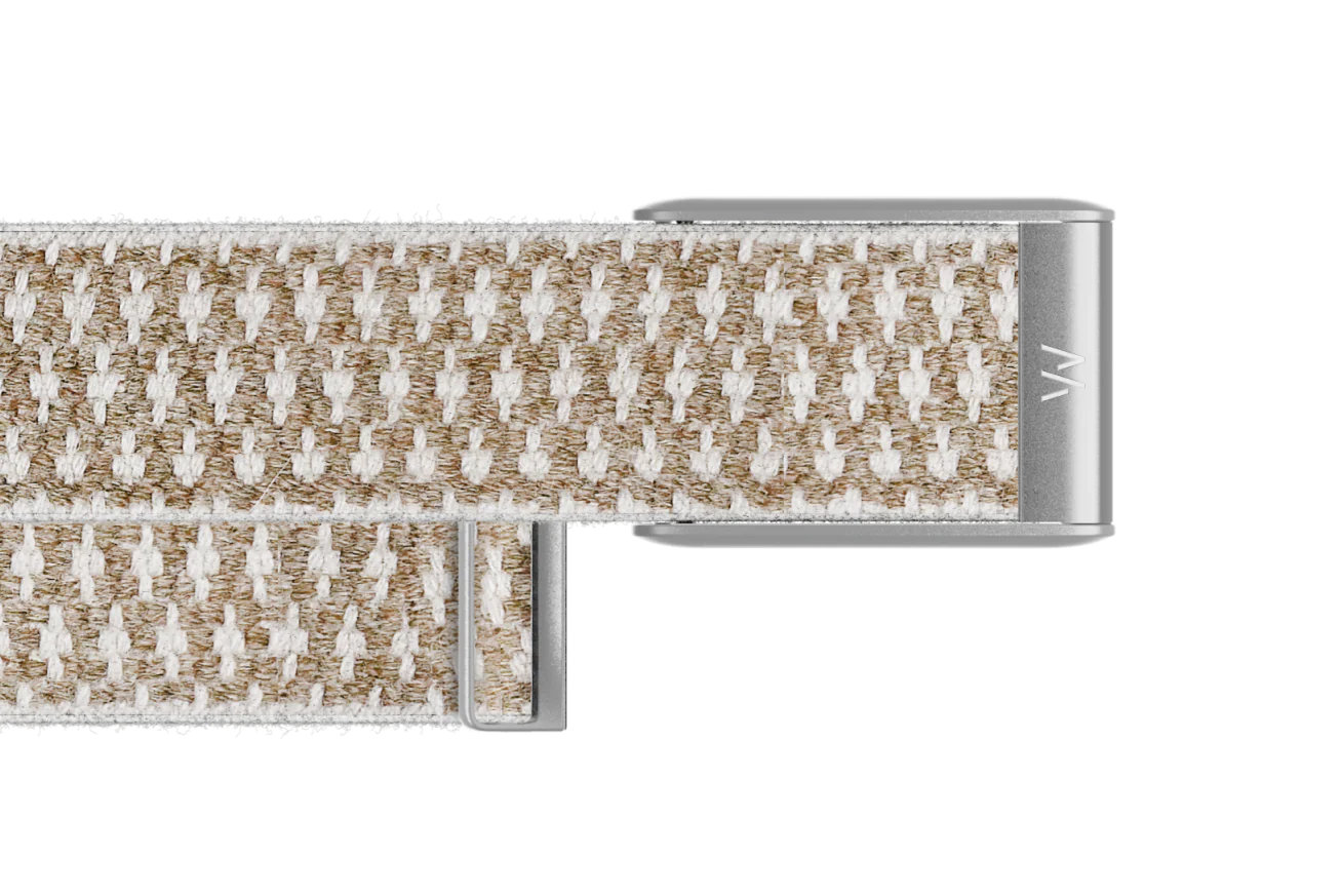 Close-up of a woven belt with a metal buckle on a white background