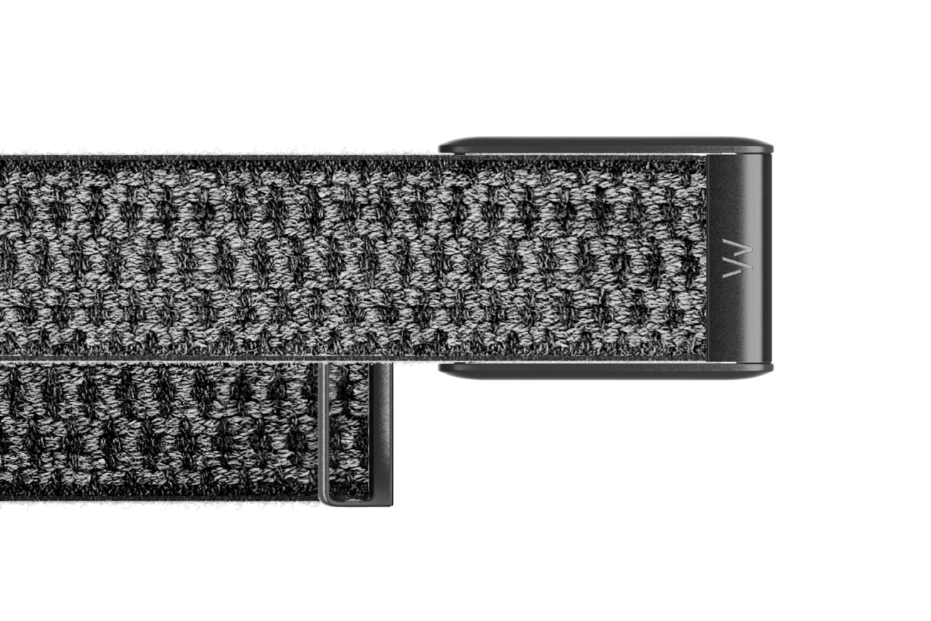 Close-up of a textured black belt with a metal buckle on a white background