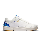 White sneaker with blue accents on a white background