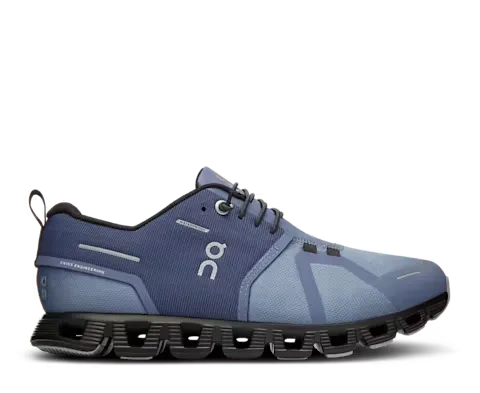 Blue running shoe with black sole on a white background