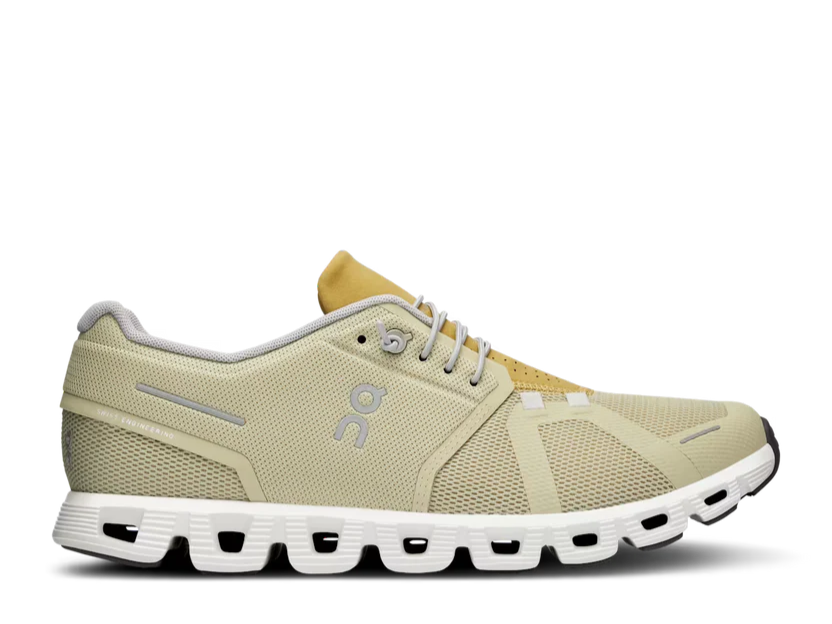 Beige running shoe with white sole on a white background