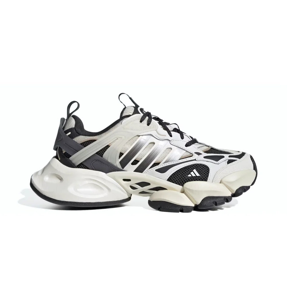 White and black sneakers with a brand logo on a white background